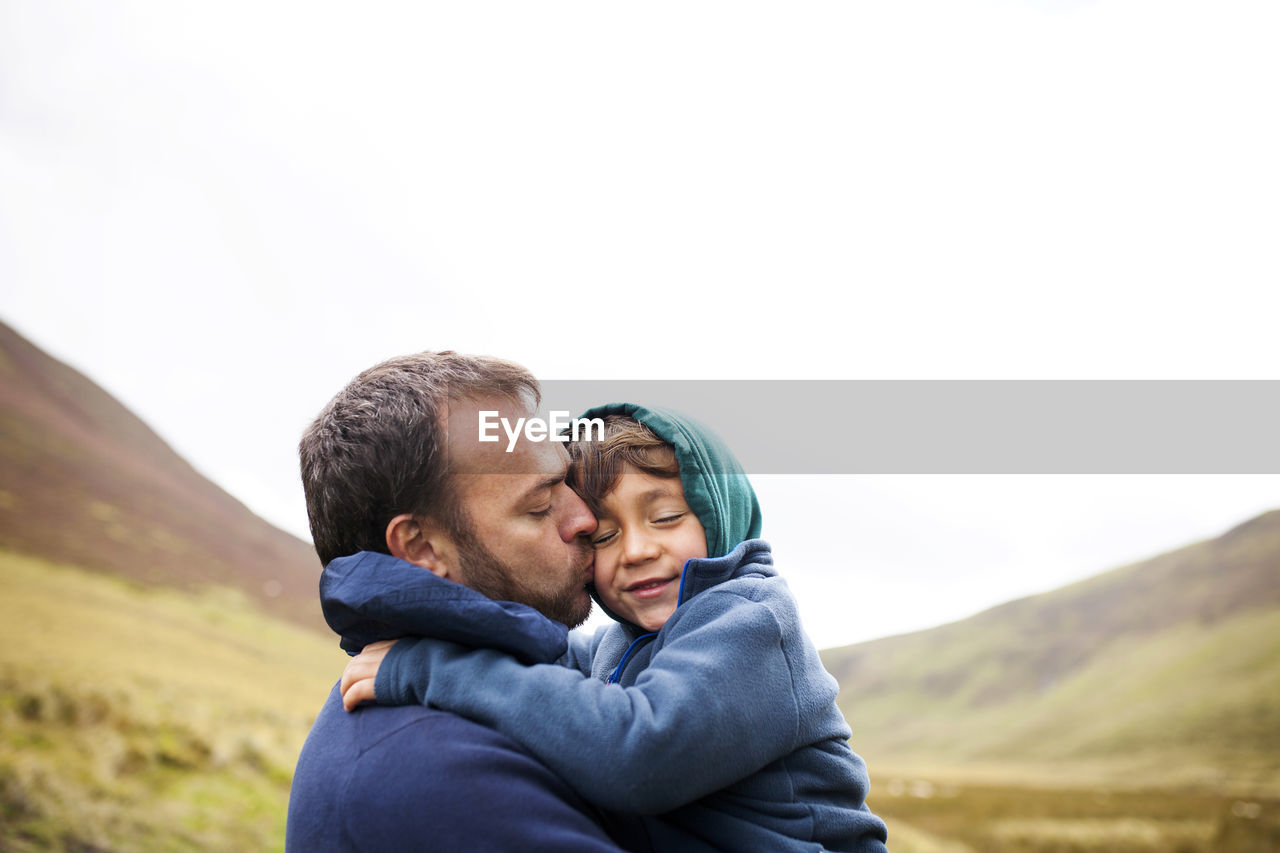 Uk, bala, father and son hugging each other