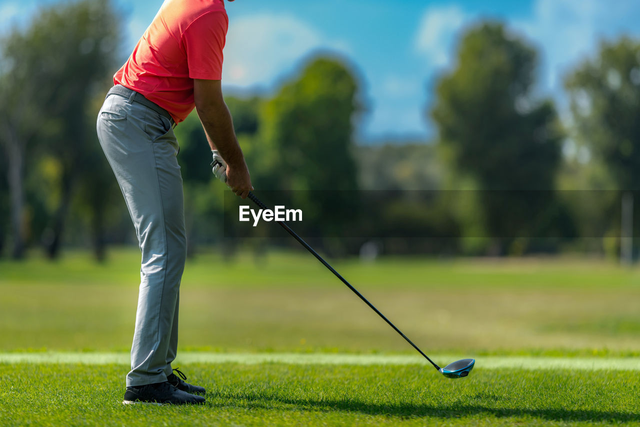 Unrecognizable golfer on a tee box, ready to swing