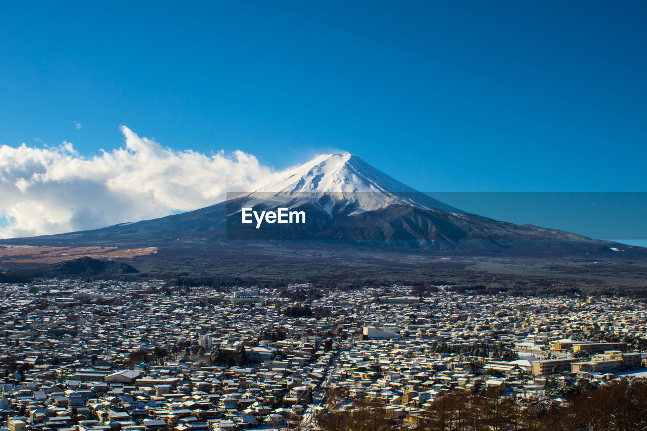 Scenic view of mountains against cloudy sky