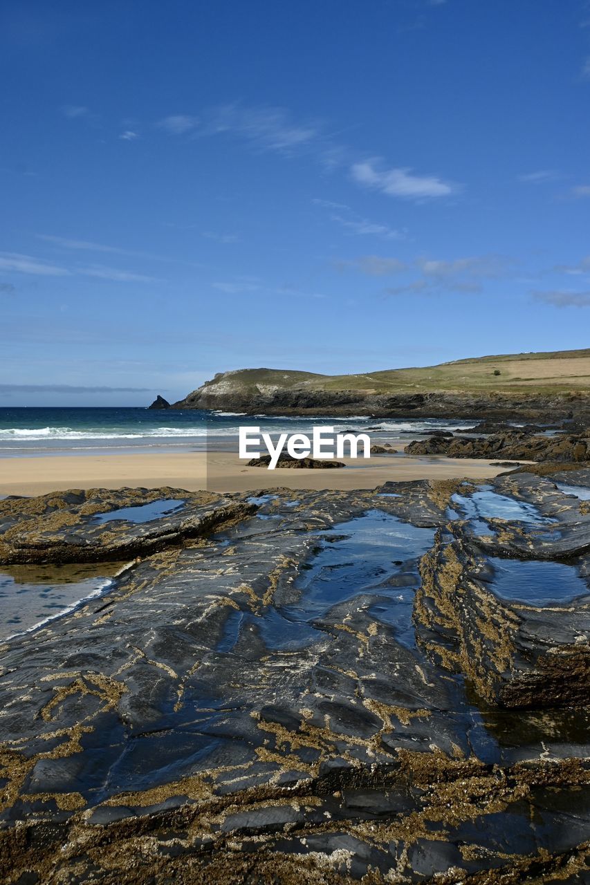 Scenic view of beach against blue sky