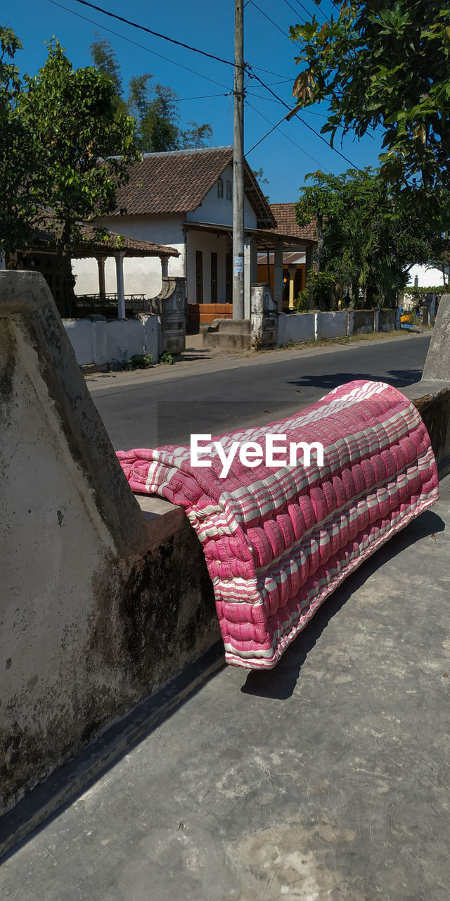 EMPTY STREET AMIDST HOUSES AGAINST BUILDINGS