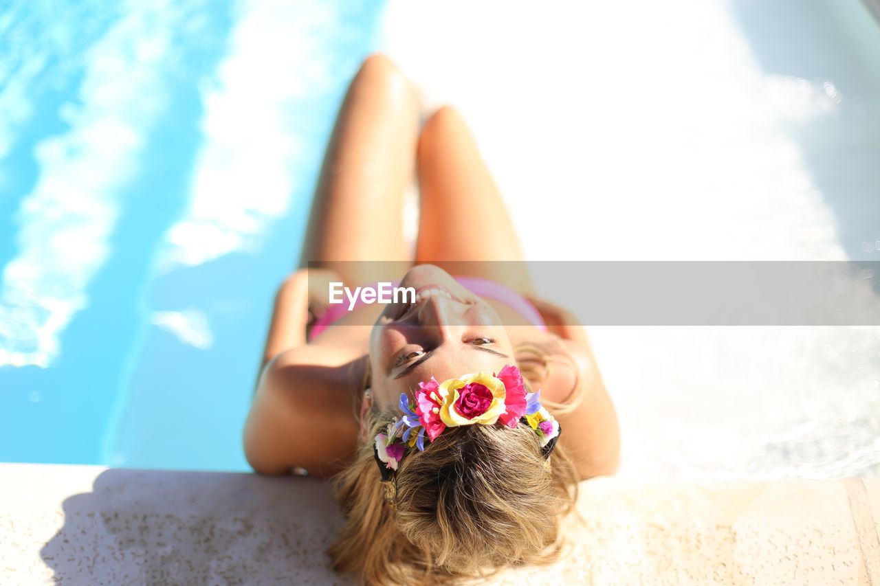 High angle view of woman relaxing in swimming pool