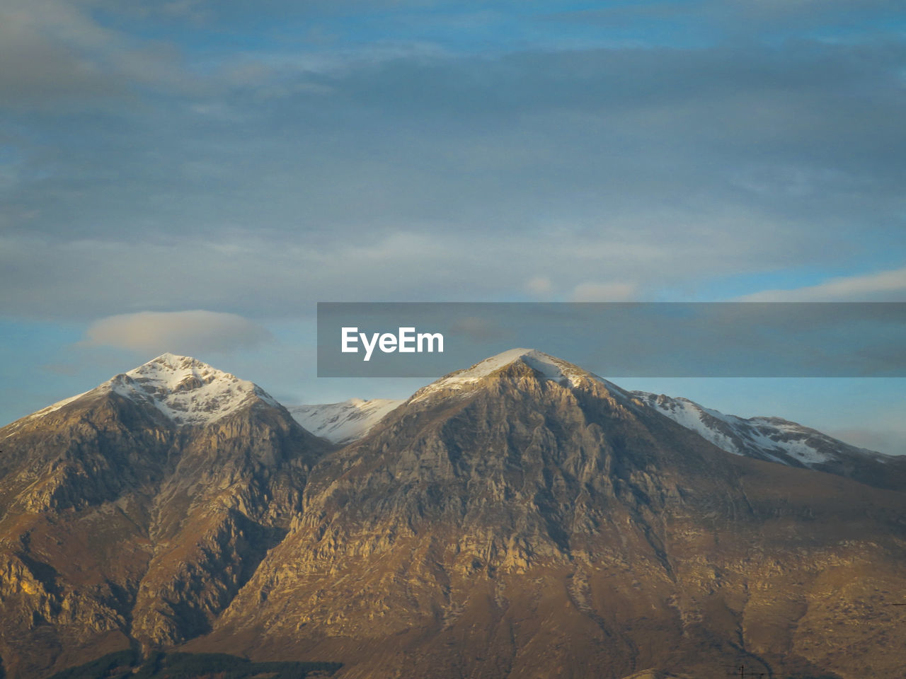 Monte velino, abruzzo italy.  apennines.  mountain range with snowy peaks and blue sky.