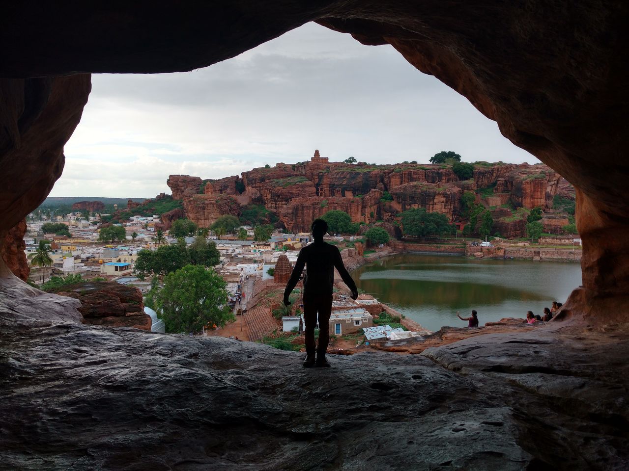 Rear view of a man overlooking rocky landscape