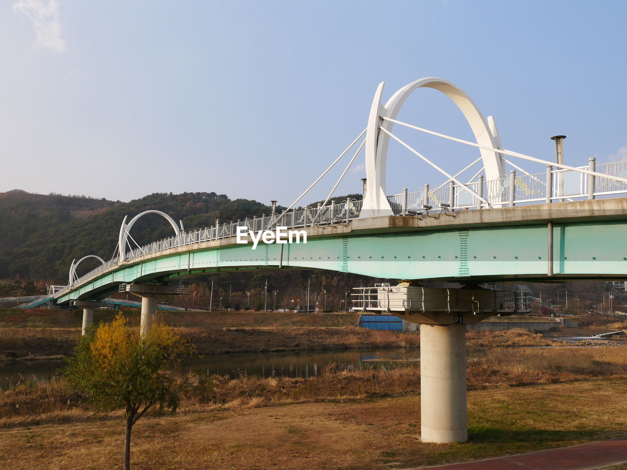 FERRIS WHEEL AGAINST BRIDGE