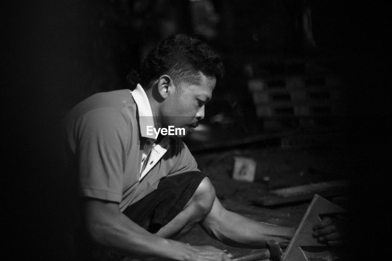 Side view of man working in factory