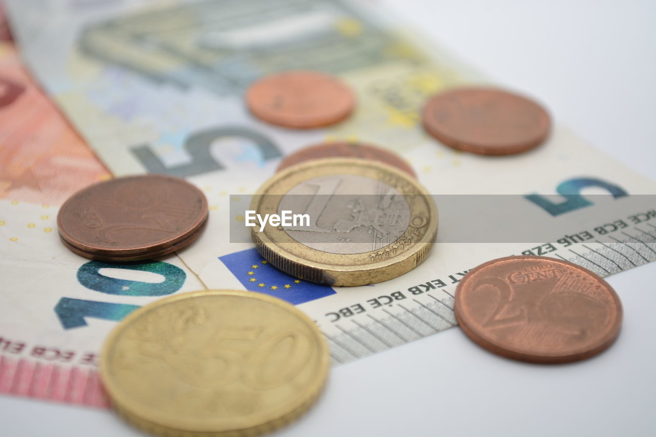 CLOSE-UP OF COINS IN CONTAINER