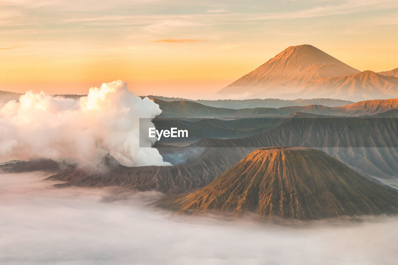 Smoke emitting from volcano against sky