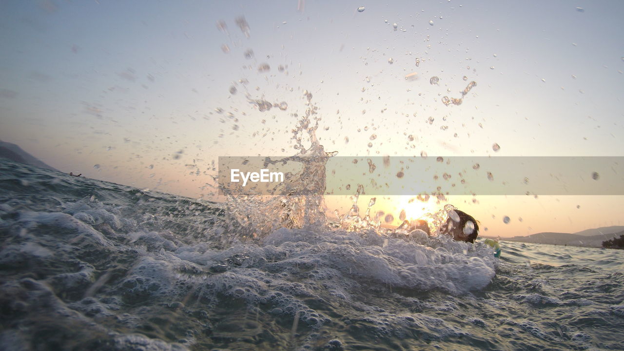 Close-up of sea water against sky during sunset