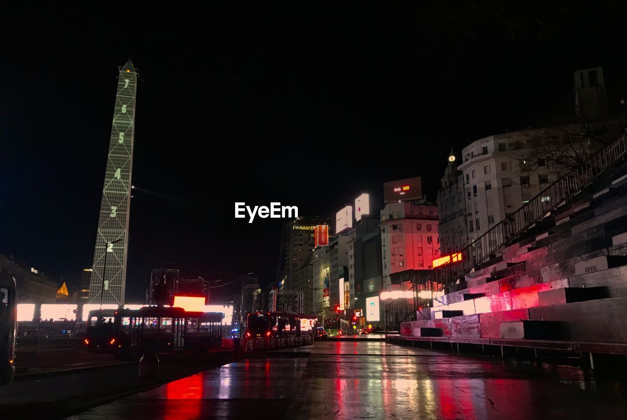 ILLUMINATED CITY BUILDINGS AT NIGHT