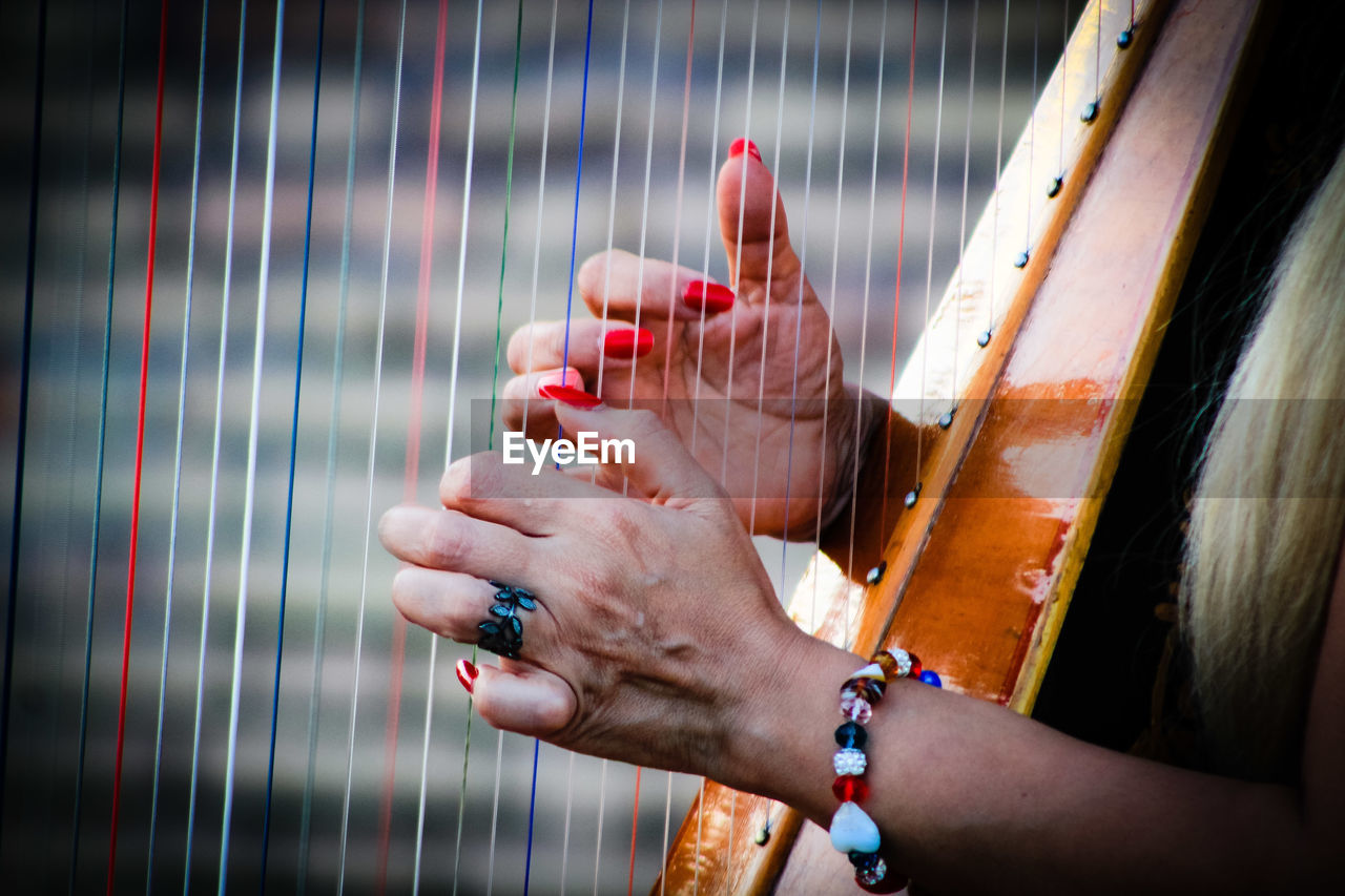 Close-up of woman hands playing string instrument