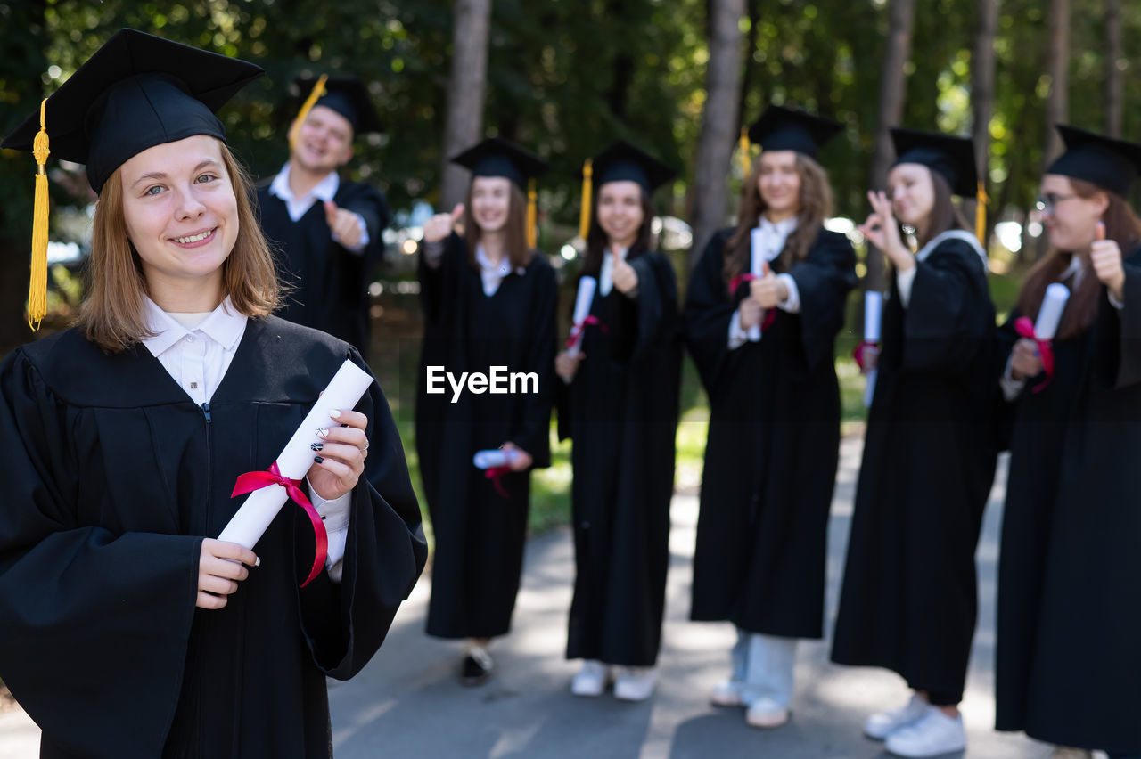 rear view of students wearing graduation gown