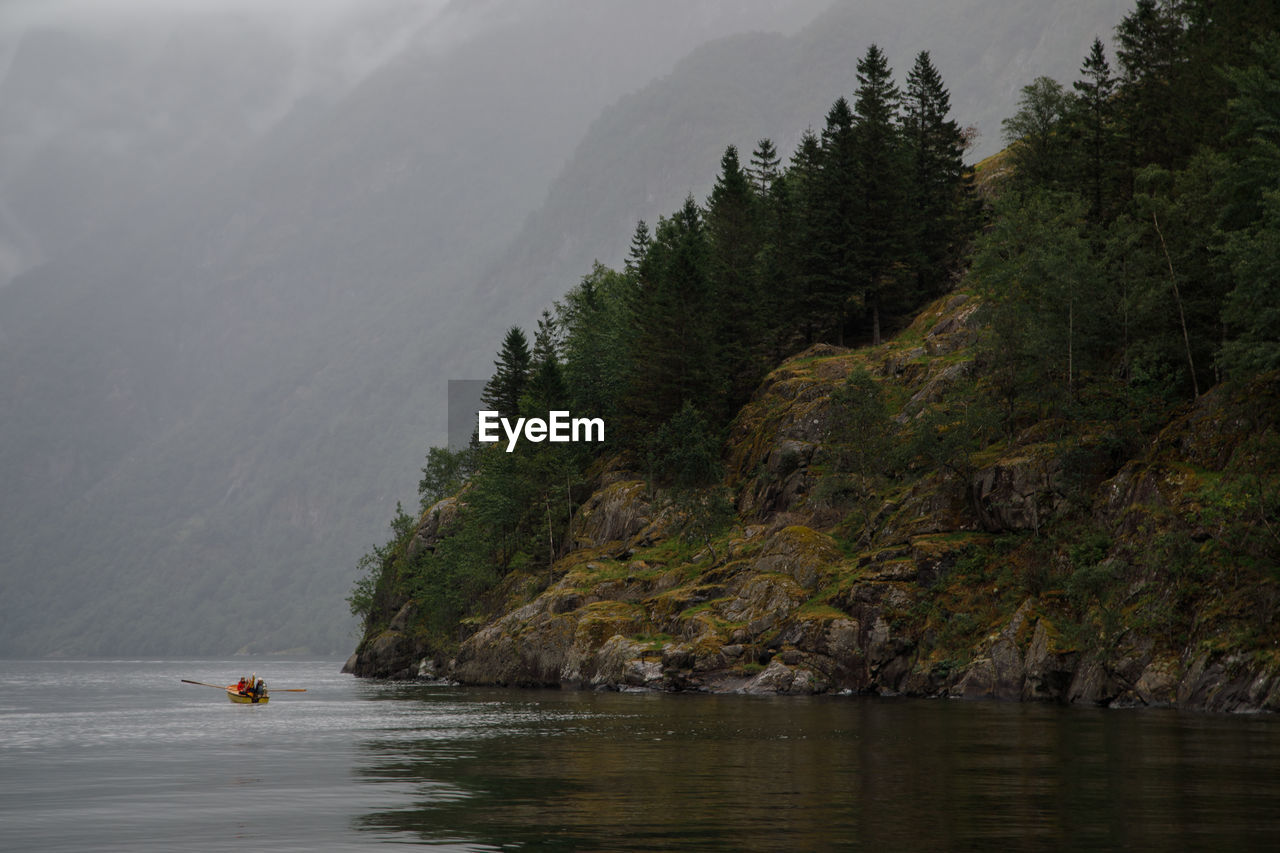 Scenic view of sea by mountain