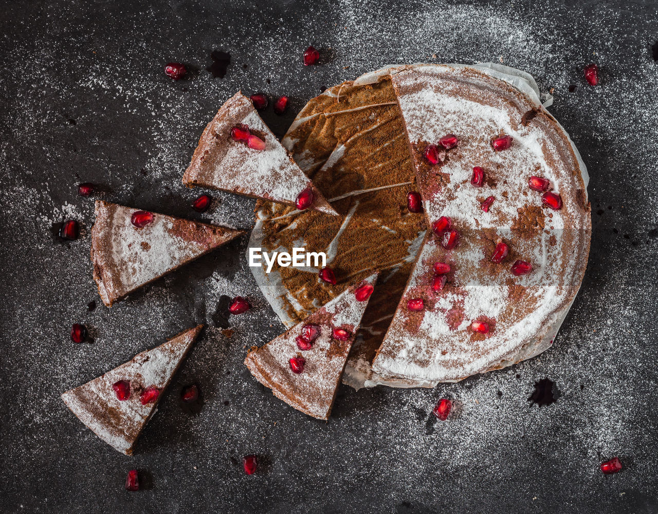 High angle view of chocolate cake with pomegranate seeds on table