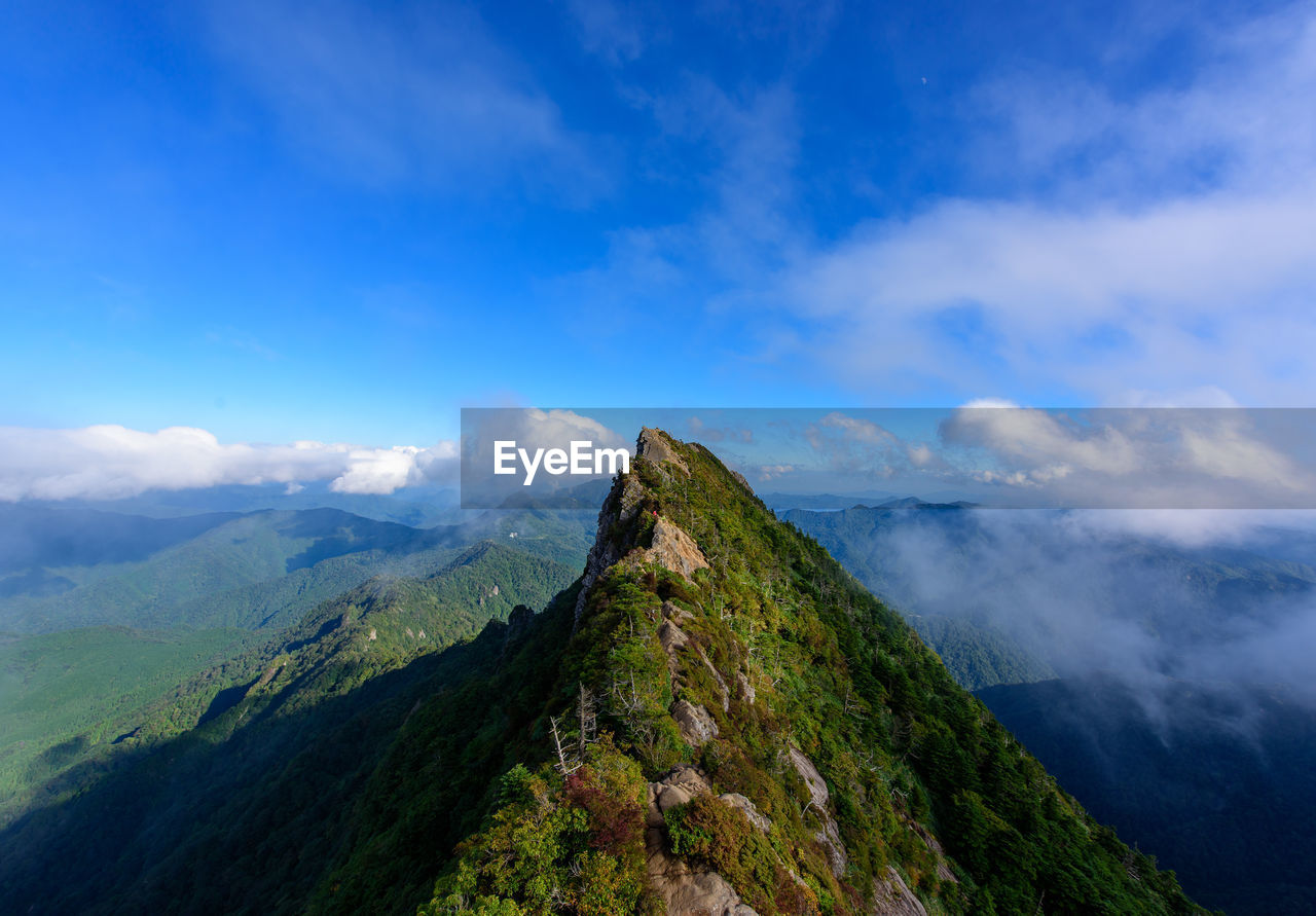 Scenic view of mountain against cloudy sky