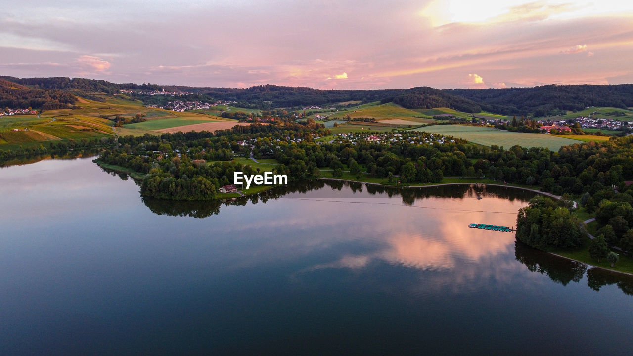 Scenic view of lake against sky during sunset