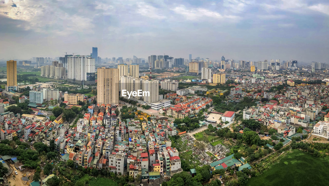 High angle view of modern buildings in city against sky