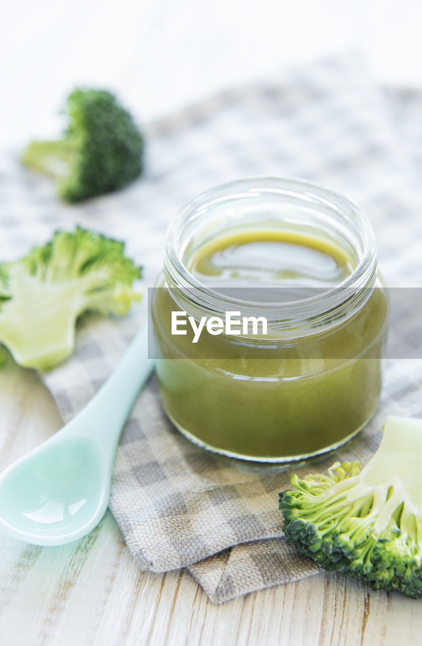 Baby food. organic green broccoli puree with ingredients. mashed broccoli and peas