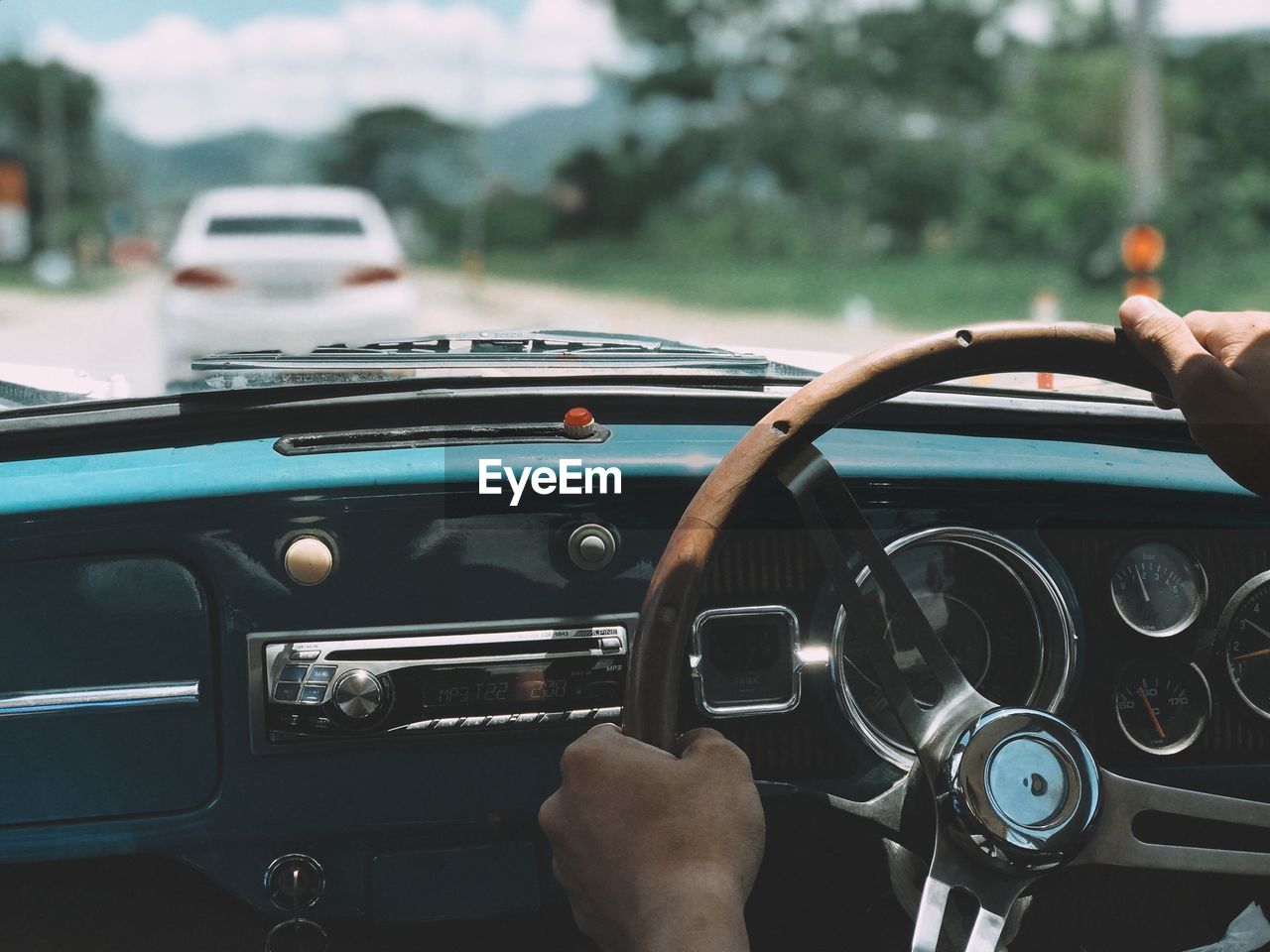 Cropped hands of man driving car