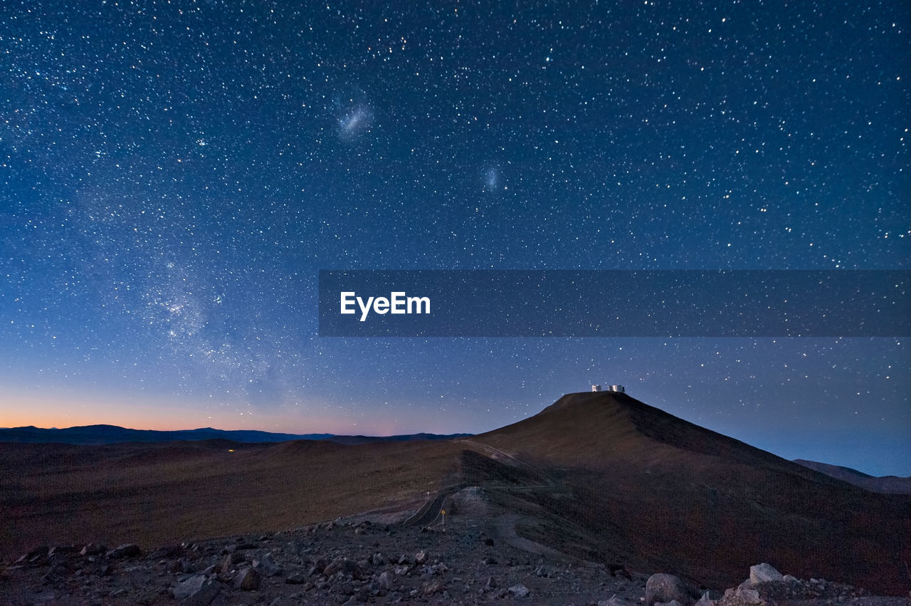 Scenic view of mountain against sky at night