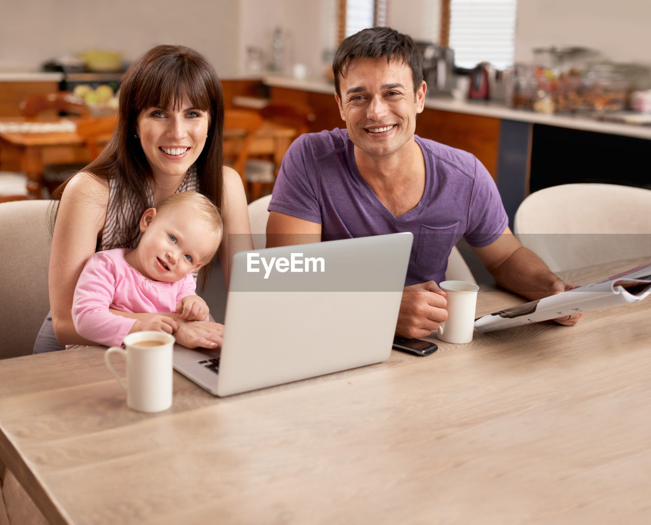 laptop, adult, wireless technology, technology, computer, female, women, using laptop, smiling, togetherness, family, happiness, indoors, communication, parent, men, domestic life, person, child, emotion, internet, two people, domestic room, lifestyles, home interior, table, computer network, sitting, bonding, positive emotion, cheerful, furniture, childhood, business, human face, casual clothing, clothing, father, food and drink, portrait, love, living room, one parent, cup, convenience, enjoyment, mature adult, portability, front view, working, mug, desk, conversation, room, drink, young adult, looking, relaxation