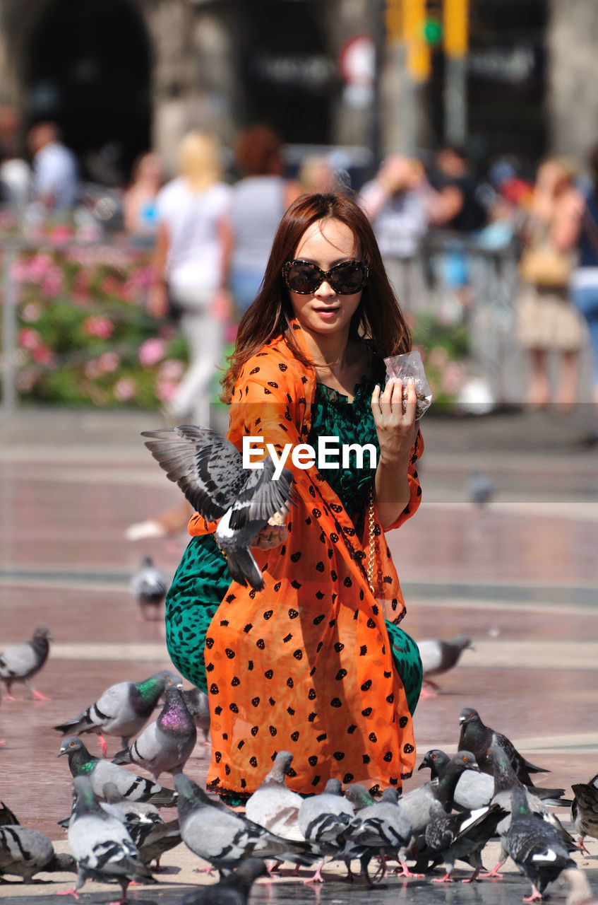 PORTRAIT OF YOUNG WOMAN WEARING SUNGLASSES