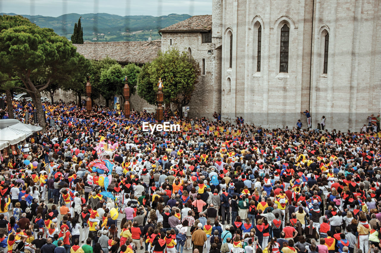 Colorful crowd participating in the feast of ceri, a traditional event in gubbio, italy.