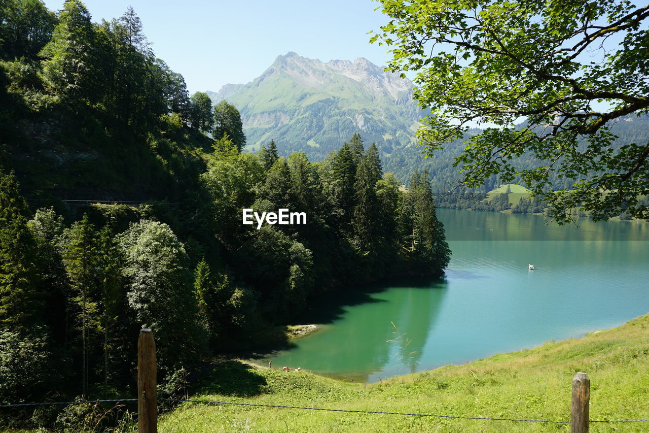 Scenic view of lake and mountains against sky