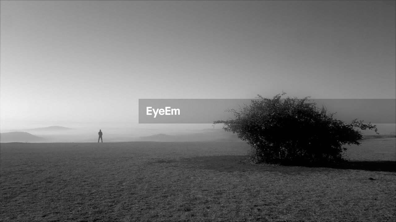 Silhouette of man in desert against sky