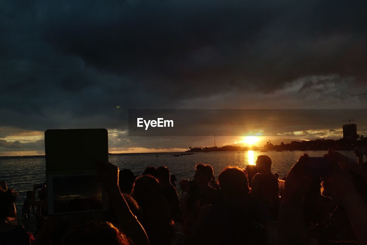 PEOPLE ON BEACH AT SUNSET