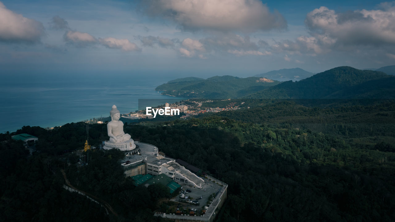 Big white buddha statue on top of mountain view point and landmark destination in phuket province 