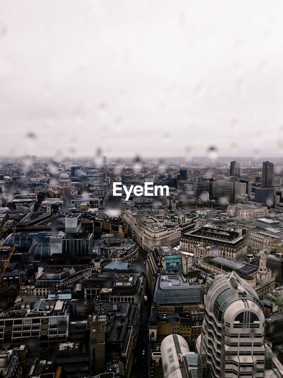 High angle view of buildings against sky with raindrops