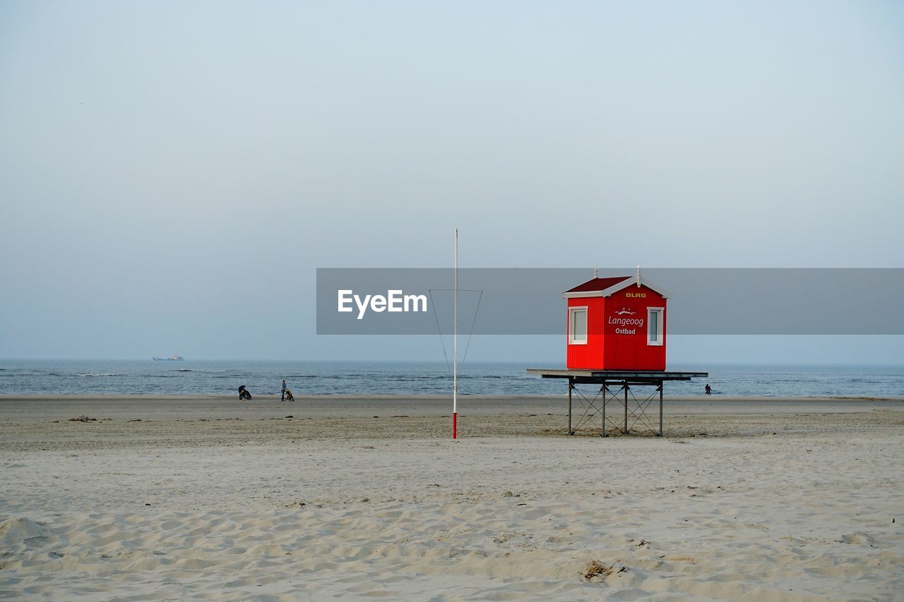 LIFEGUARD HUT ON BEACH AGAINST SKY