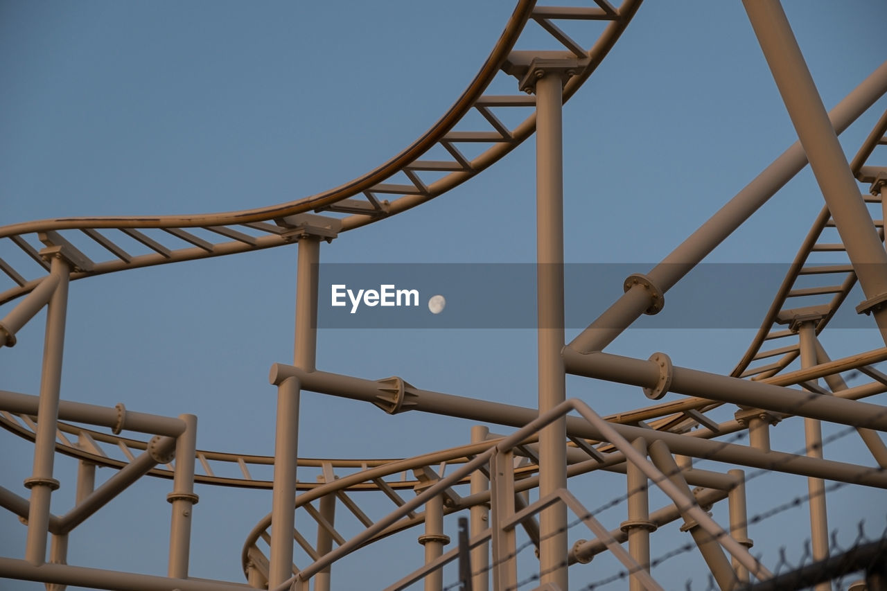 LOW ANGLE VIEW OF ROLLERCOASTER AGAINST SKY