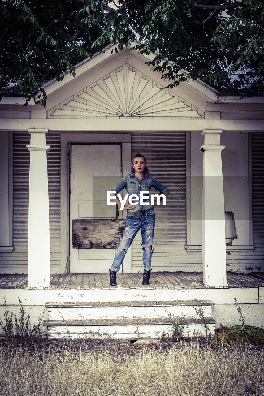 Portrait of woman standing on porch