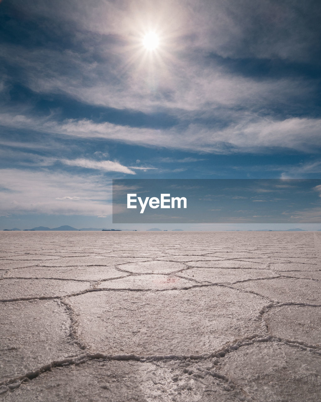 Scenic view of arid landscape against sky during sunny day