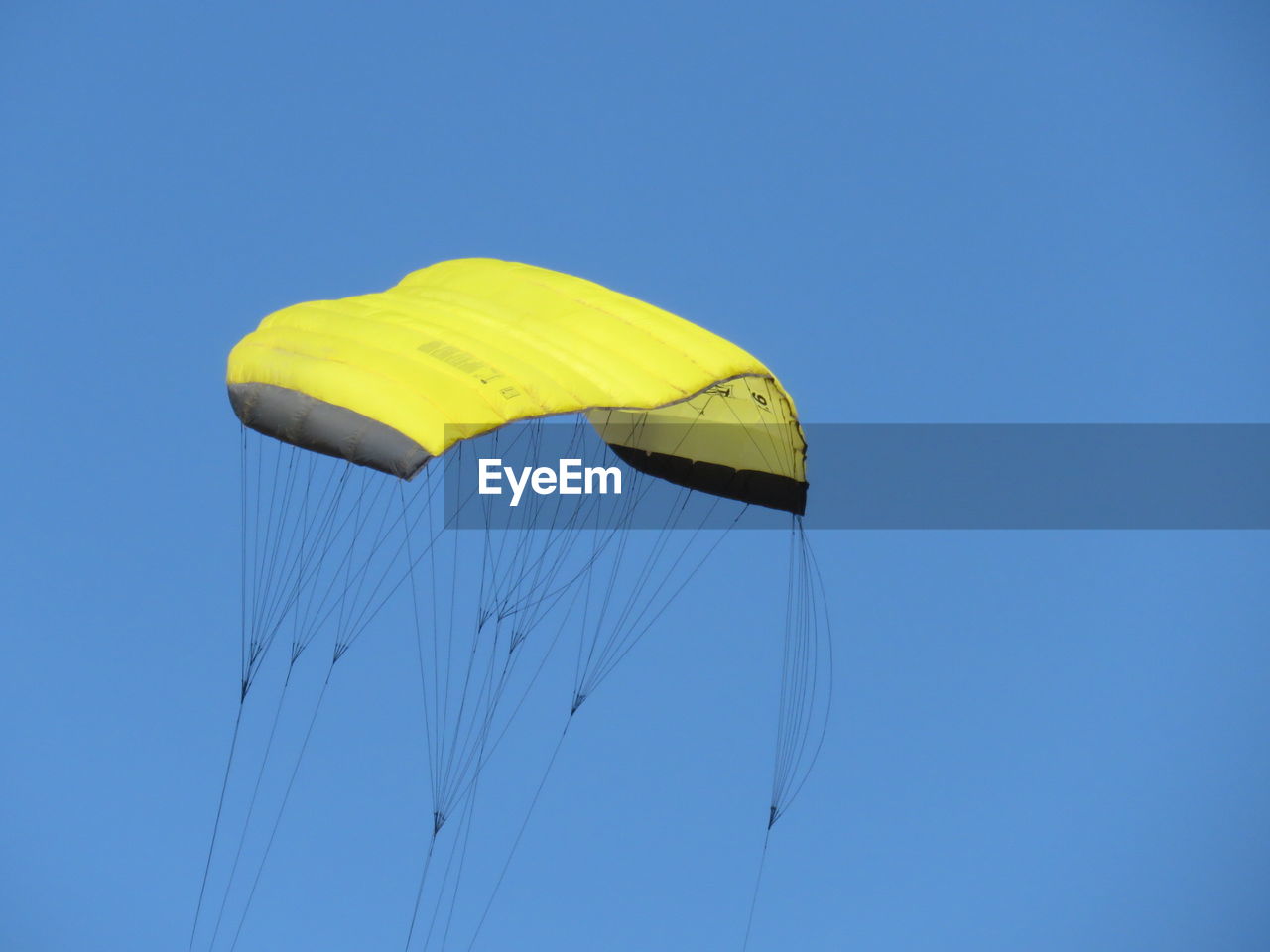 Low angle view of parachute against clear sky