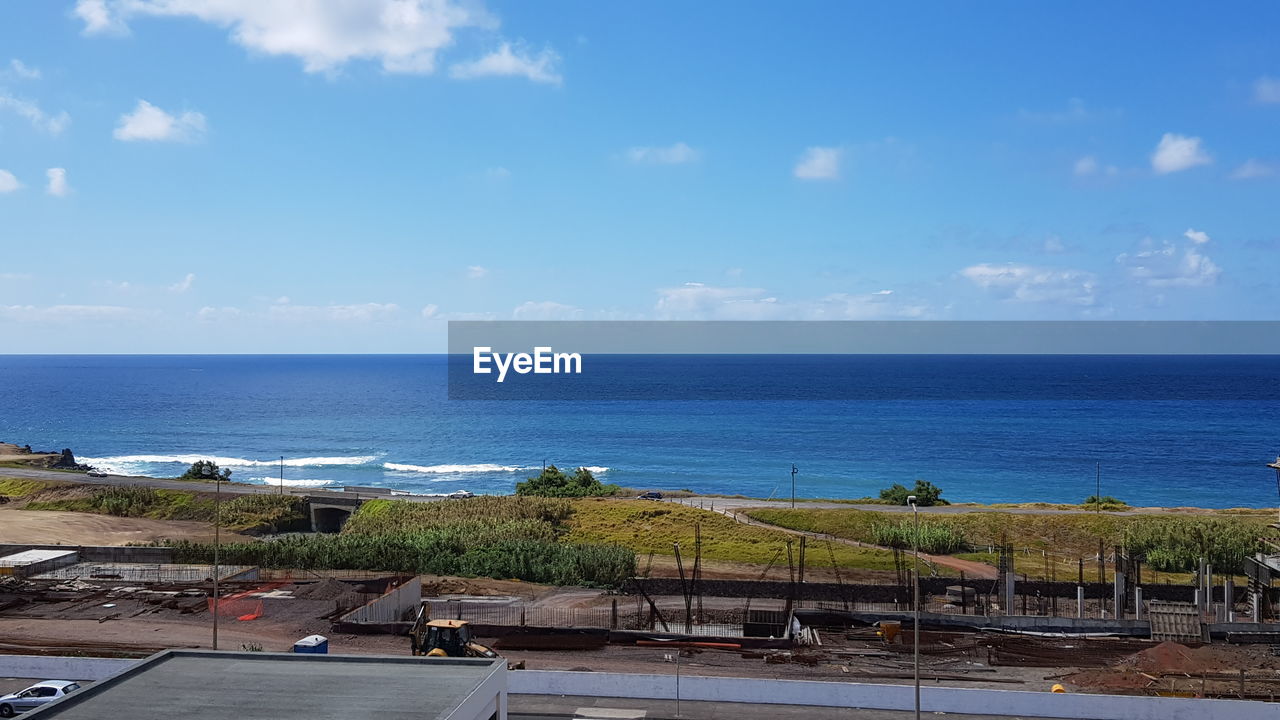 SCENIC VIEW OF BEACH AGAINST BLUE SKY