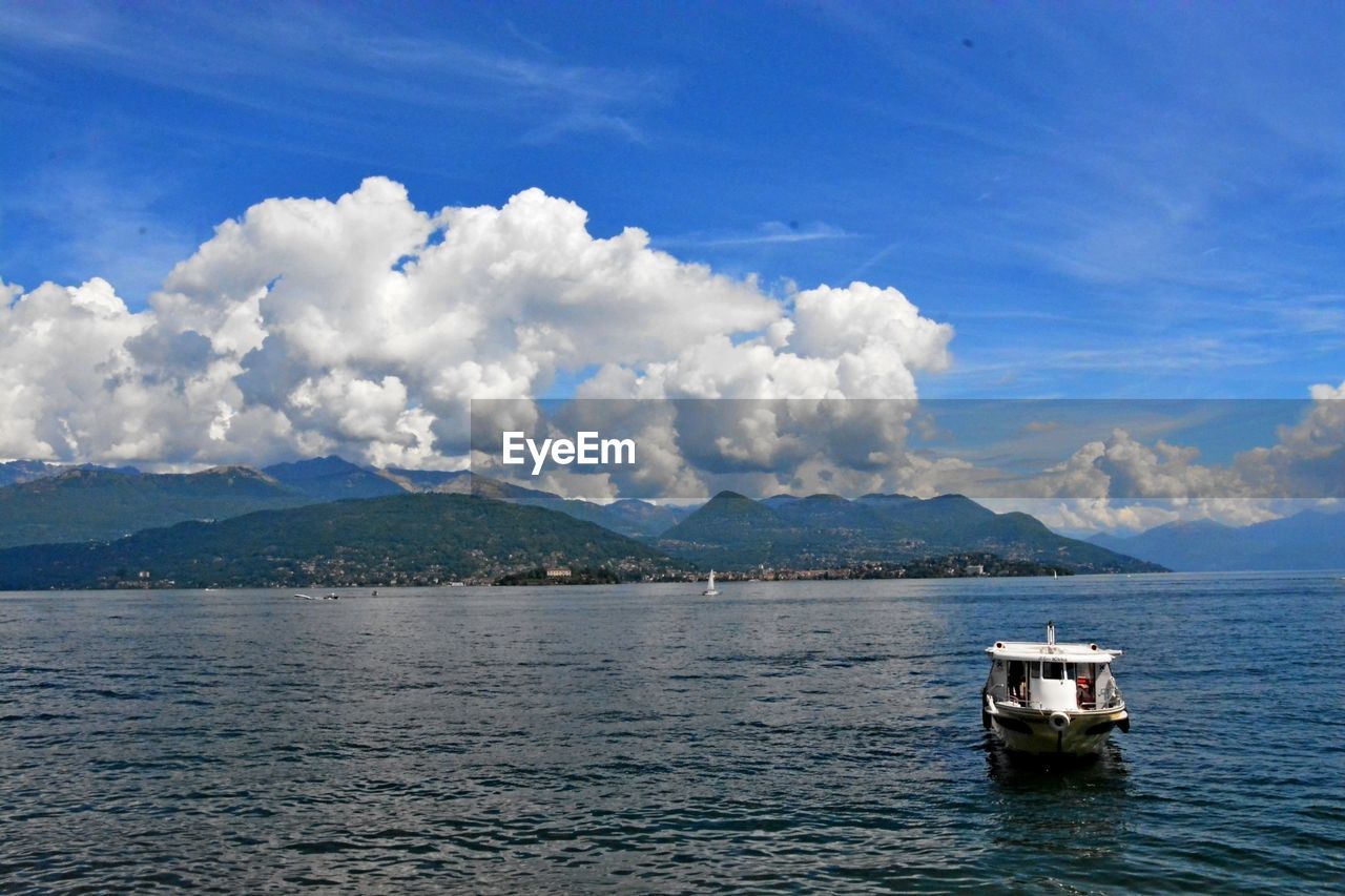 Boat moored on sea against sky