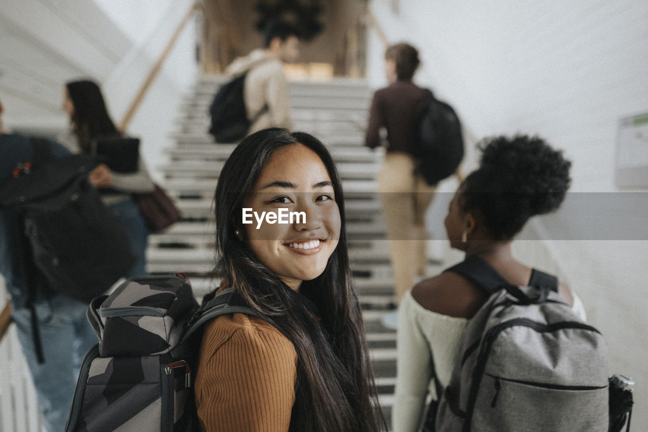 Portrait of smiling female student at university