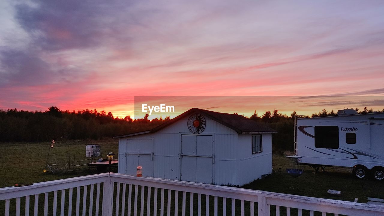 sunset, architecture, sky, built structure, cloud, evening, building exterior, house, nature, building, dusk, no people, landscape, residential district, water, scenics - nature, beauty in nature, outdoors, travel, travel destinations, transportation, twilight, orange color, city