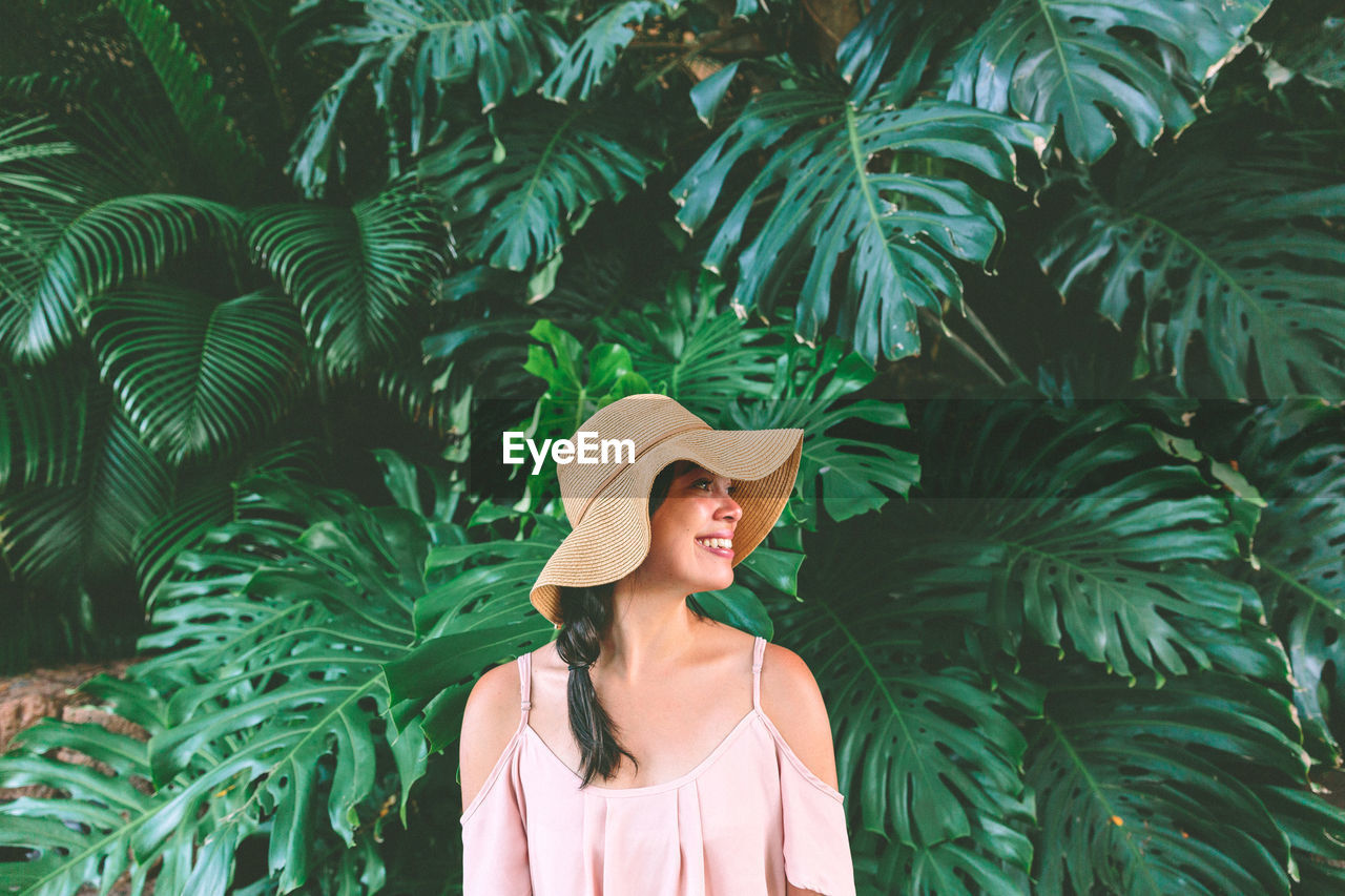 Woman standing by plant