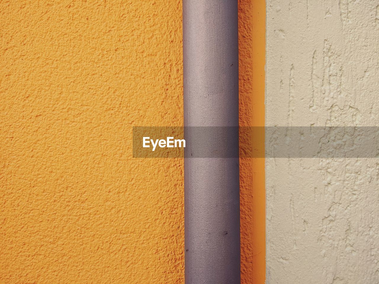 FULL FRAME SHOT OF YELLOW WALL WITH ORANGE