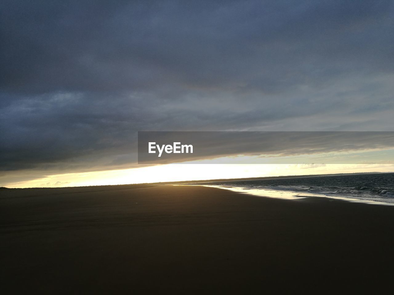 SILHOUETTE BEACH AGAINST SKY DURING SUNSET