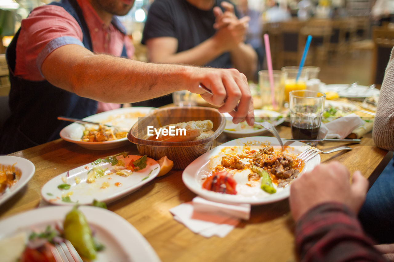 Middle eastern men enjoying a traditional iftar dinner. selective focus