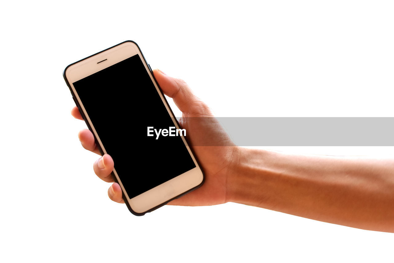 Cropped hand holding smart phone over white background