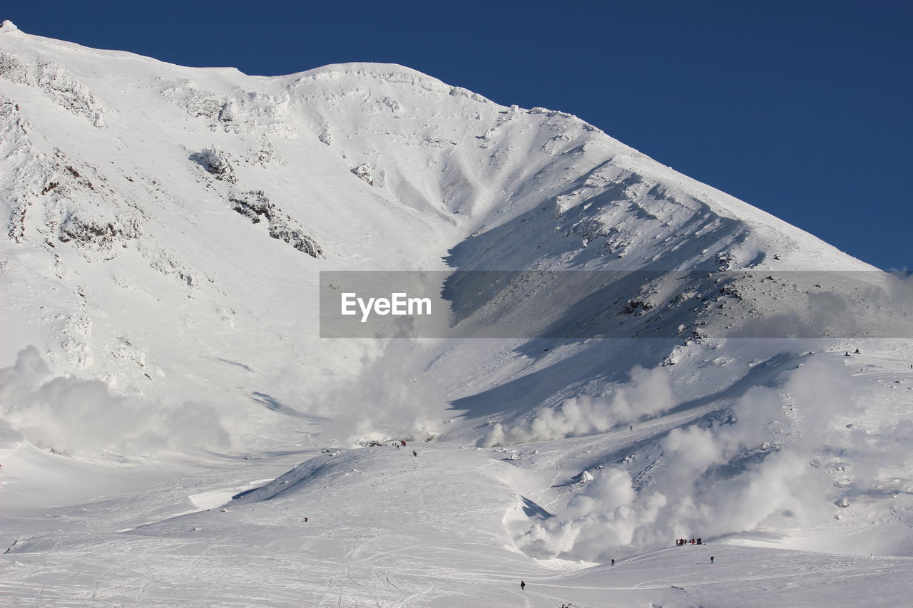 Scenic view of snow covered mountains against sky