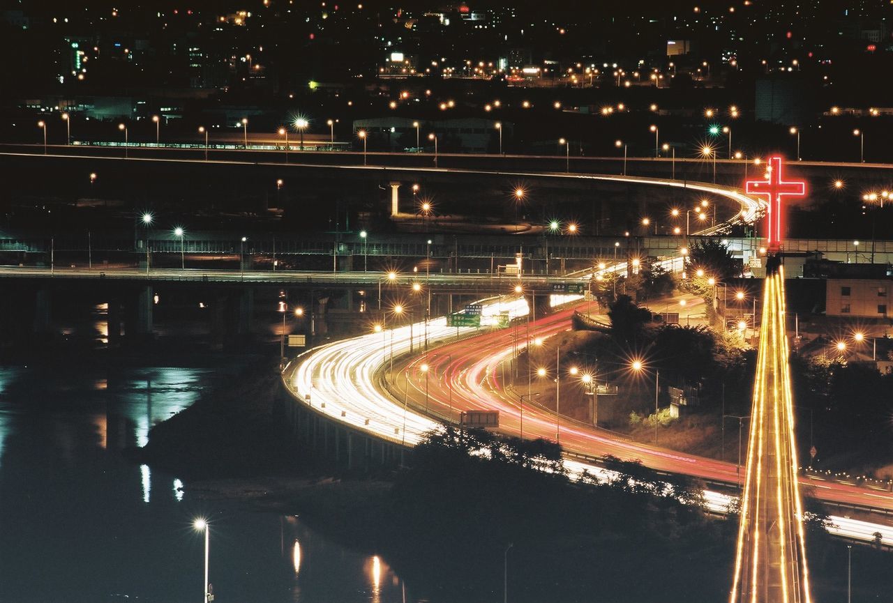 HIGH ANGLE VIEW OF LIGHT TRAILS AT NIGHT