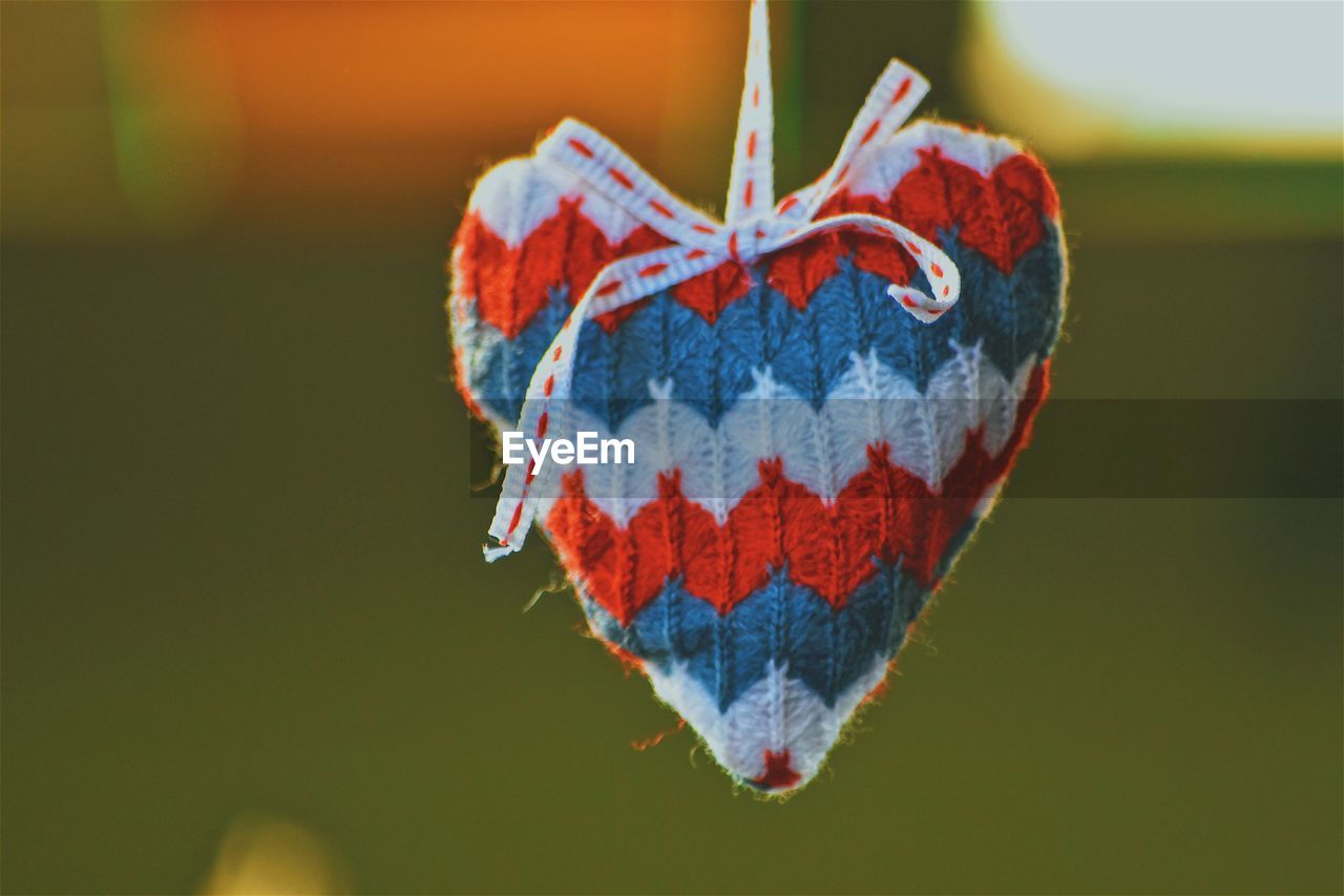 CLOSE-UP OF BUTTERFLY ON HEART SHAPE