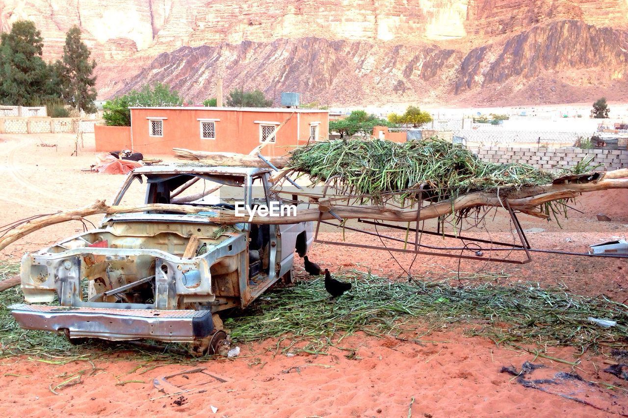 Wood on abandoned car at field